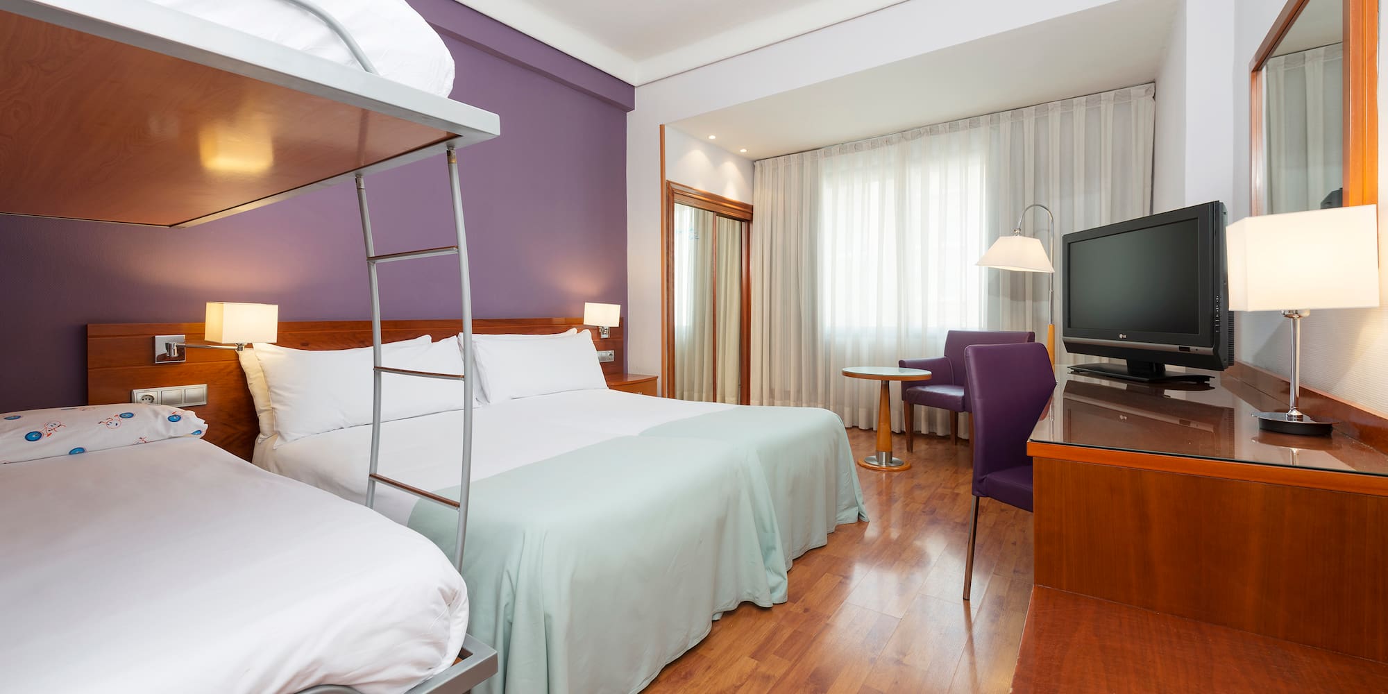 a room with a bunk bed and a television