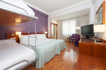 a room with a bunk bed and a television