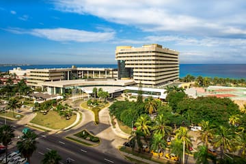 a large building with a road and trees