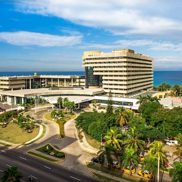 a large building with a road and trees