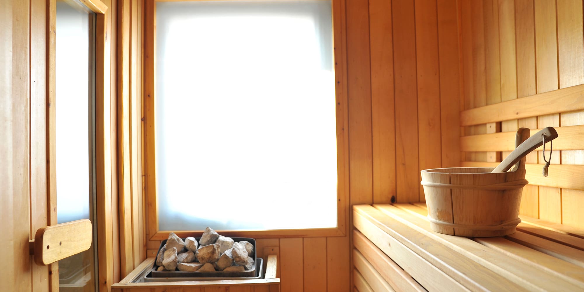 a sauna with a bucket and rocks