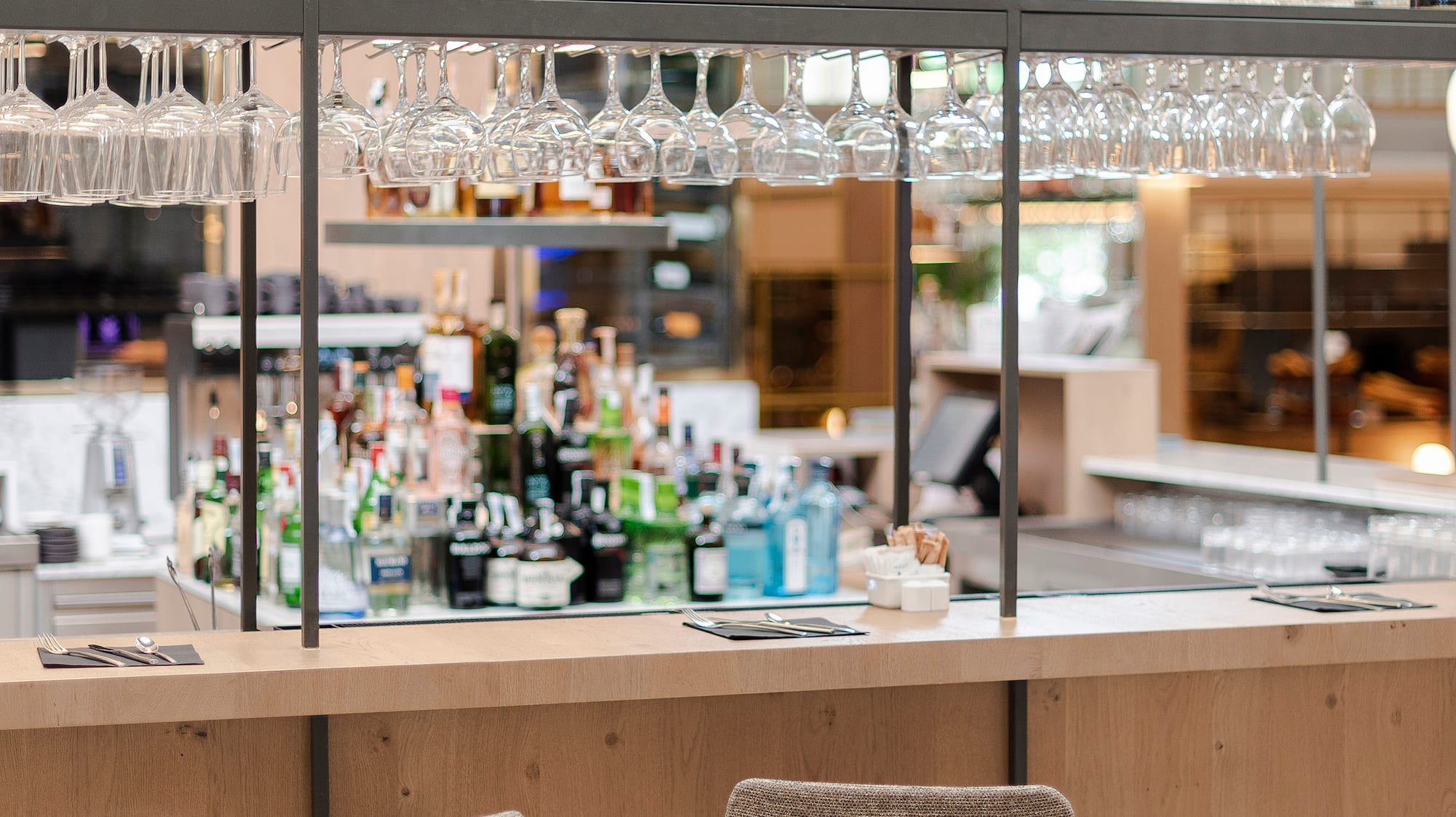 a bar with glasses and bottles