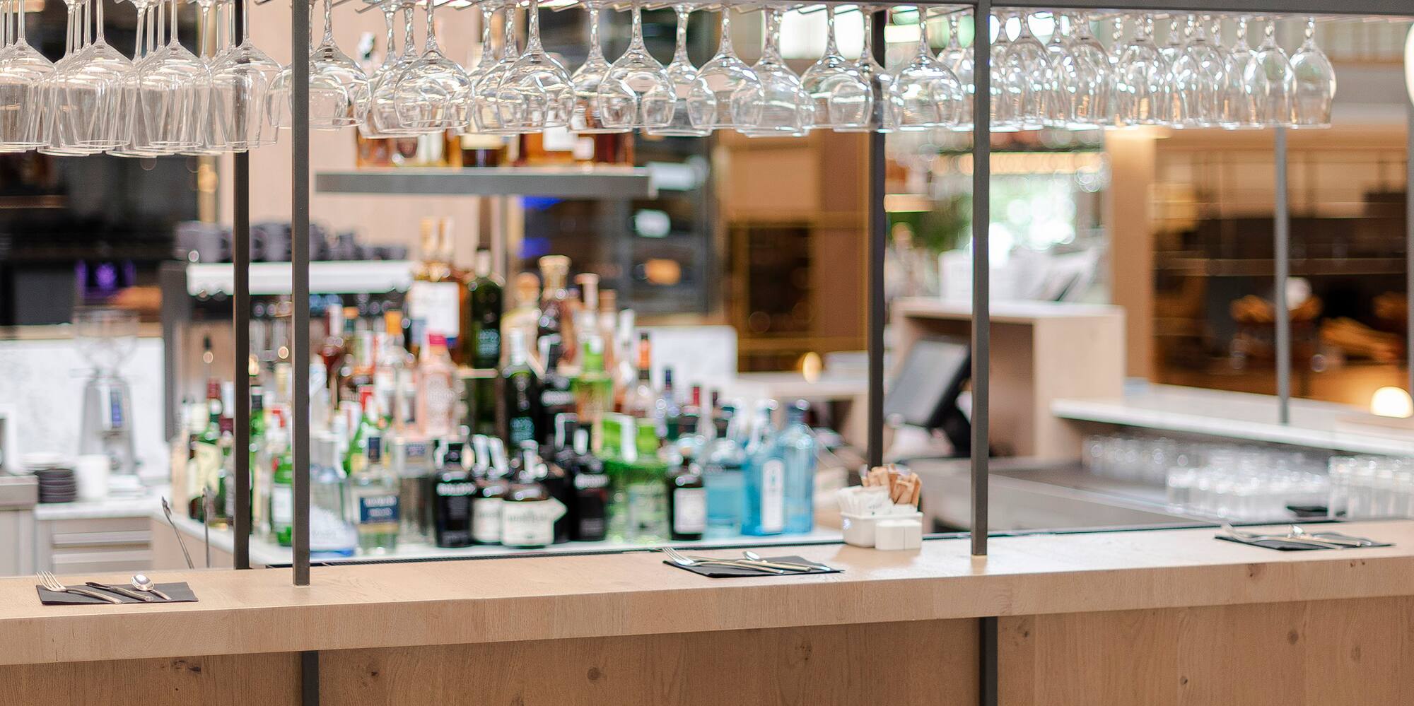 a bar with glasses and bottles