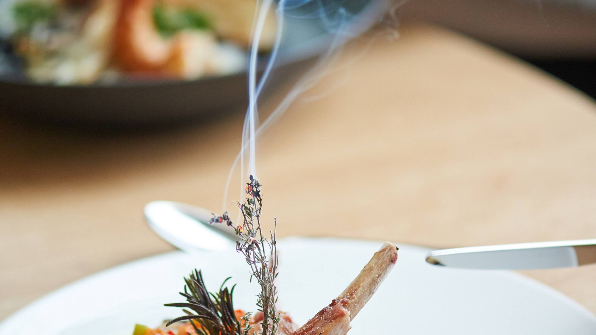 a plate of food with smoke coming out of it