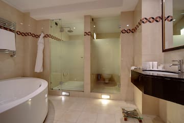 a bathroom with a tub and shower