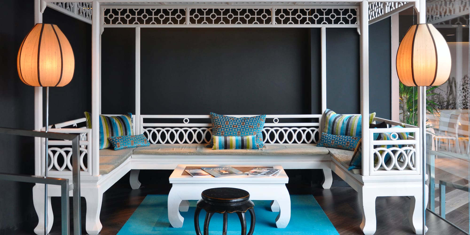 a white bench with pillows in a room