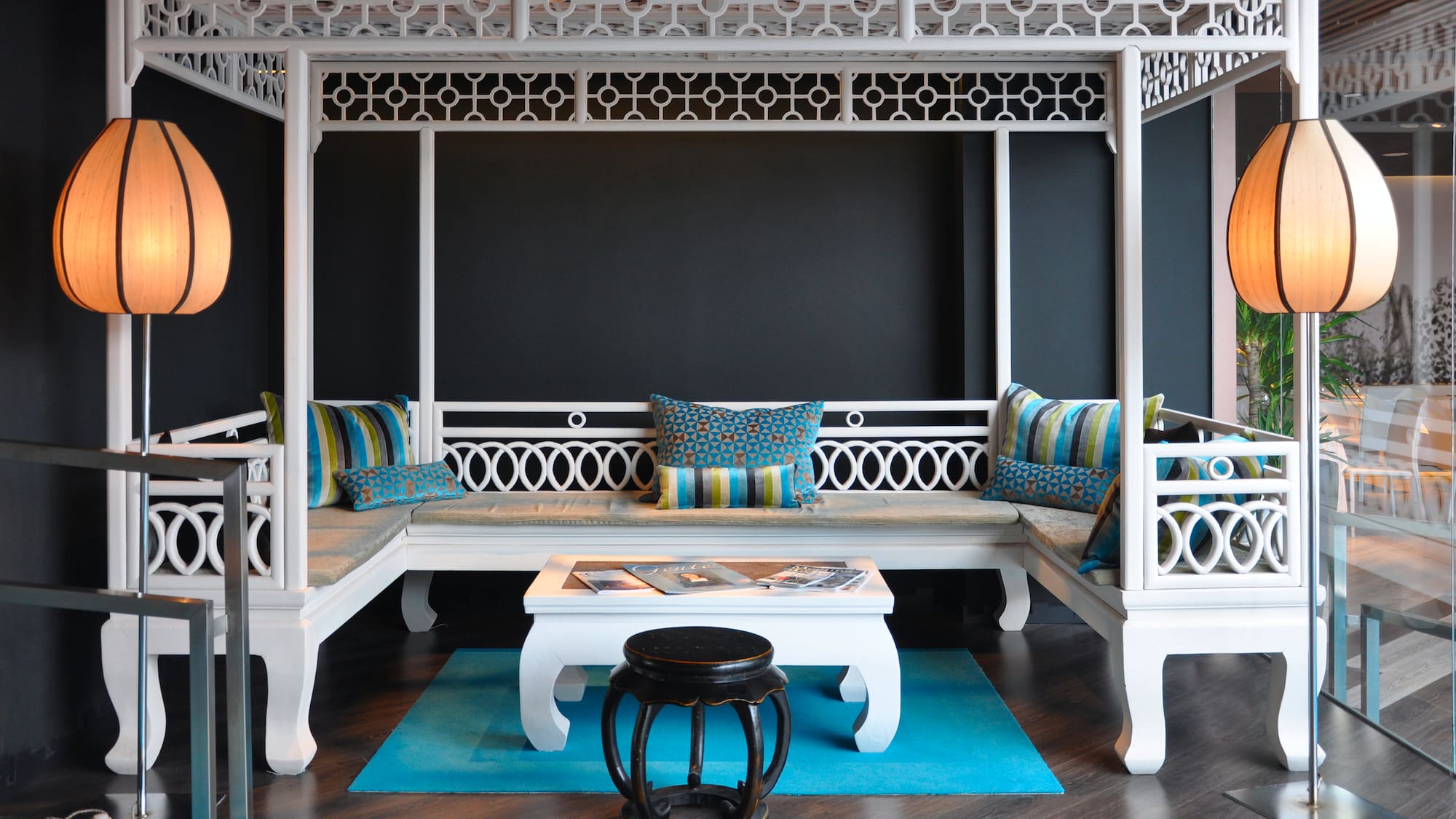 a white bench with pillows in a room