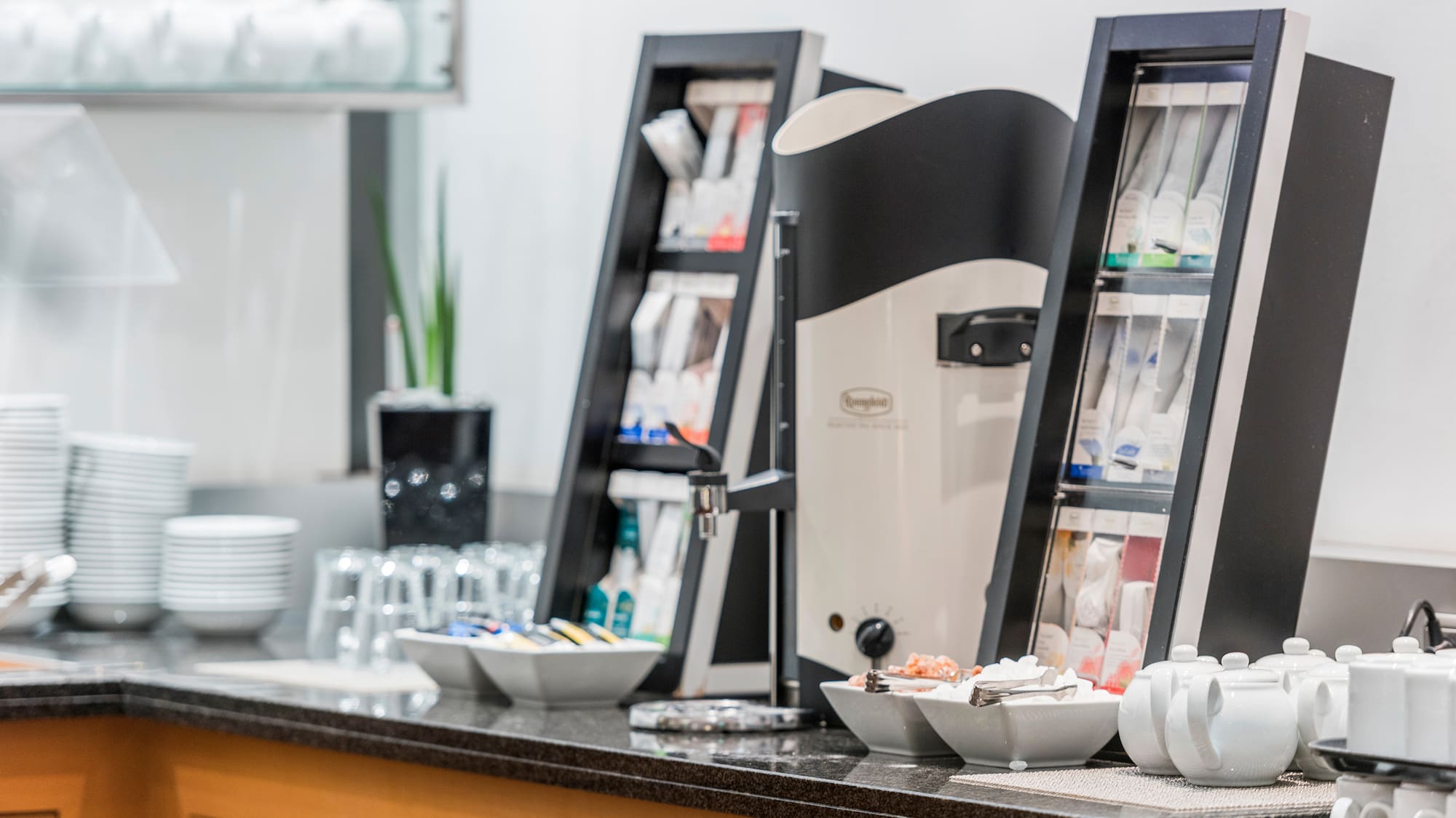 a coffee machine and cups on a counter
