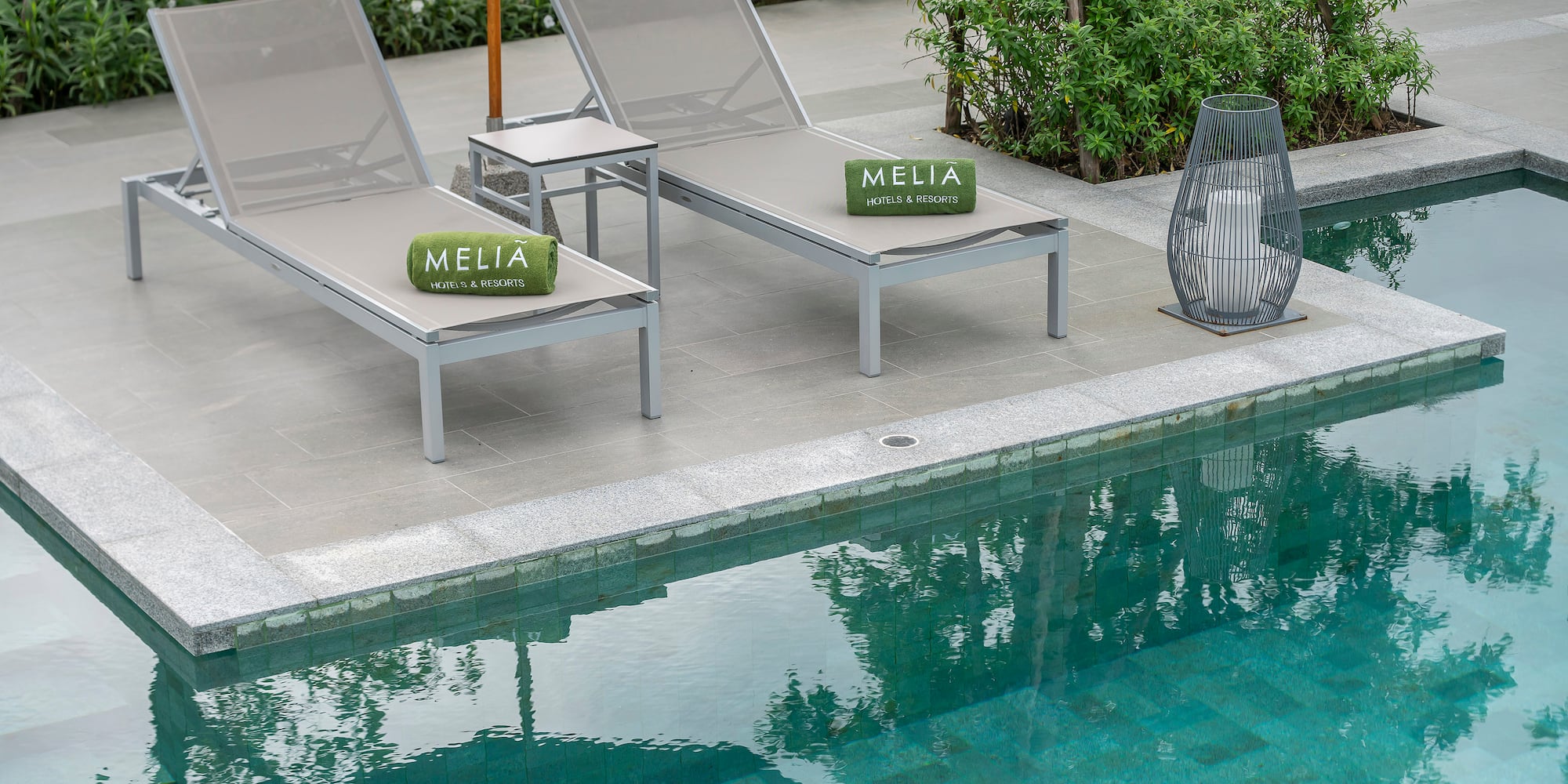 a pool with lounge chairs and a table