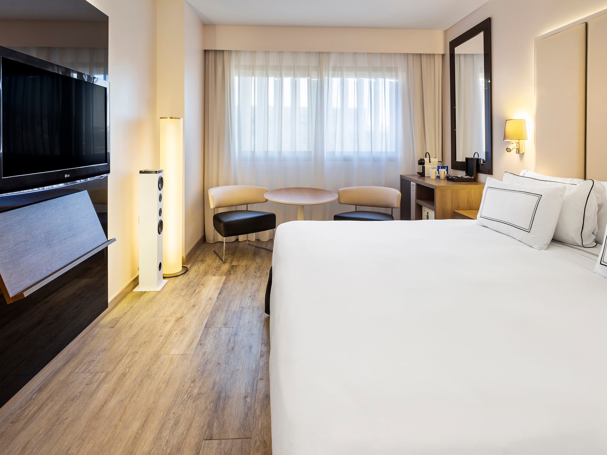 a room with a bed and a television