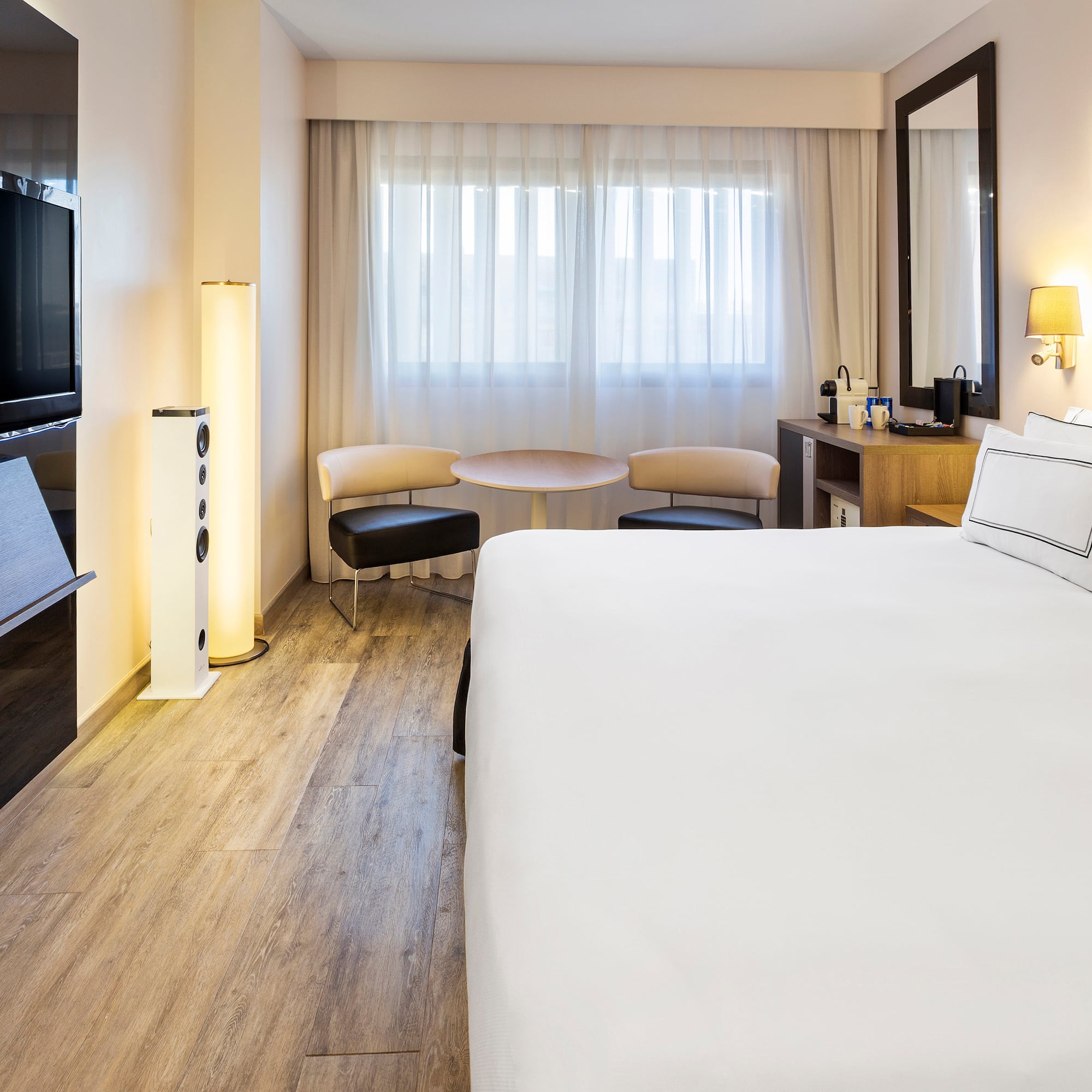 a room with a bed and a television