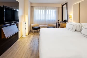 a room with a bed and a television