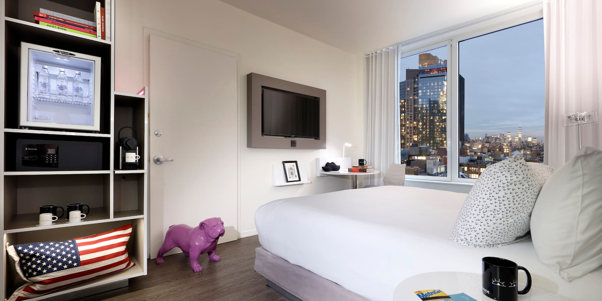 a bedroom with a large window and a large bed