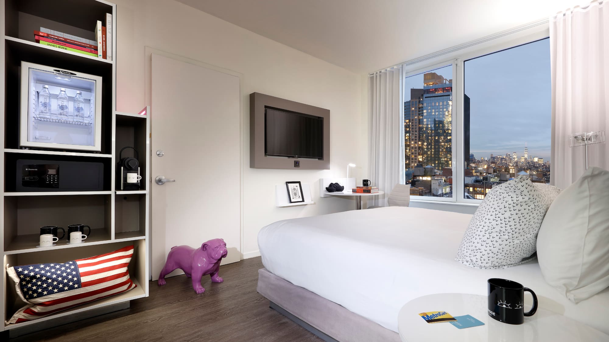 a bedroom with a large window and a large bed