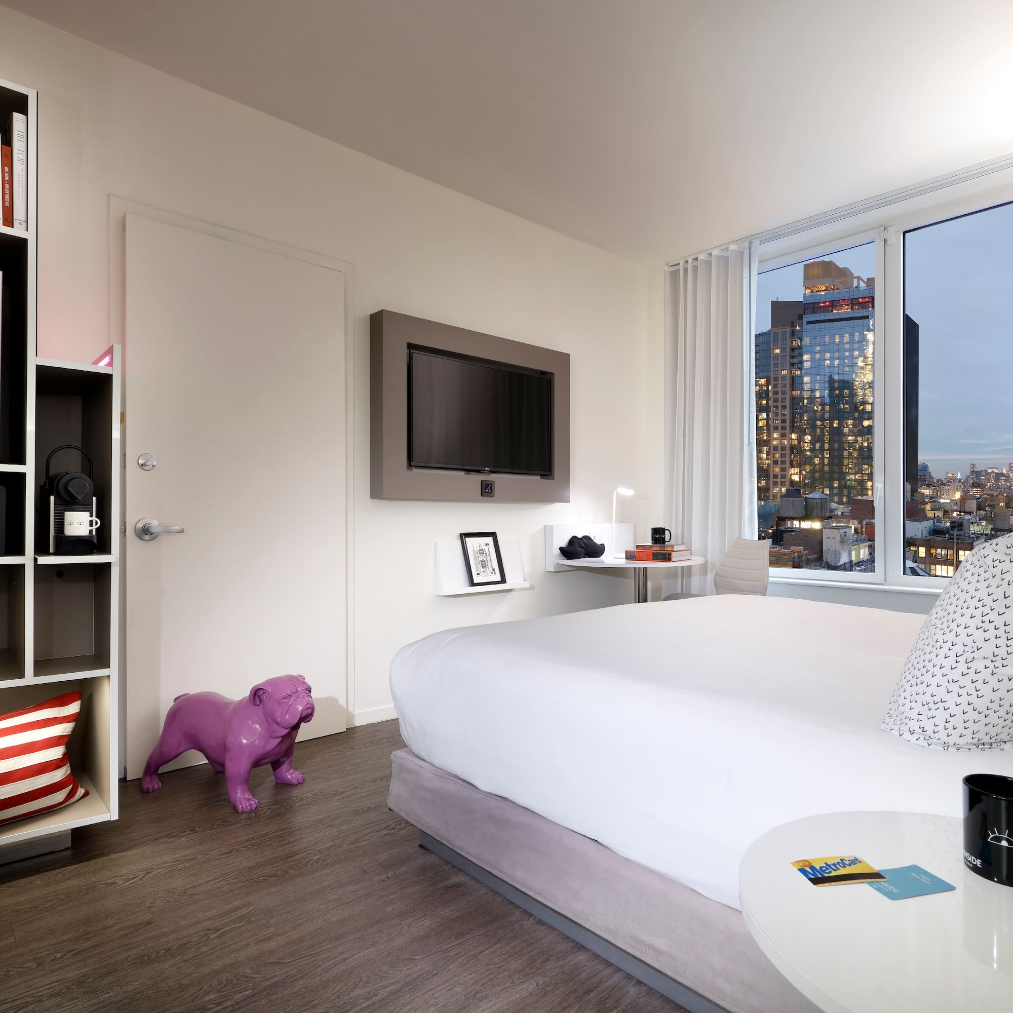 a bedroom with a large window and a large bed