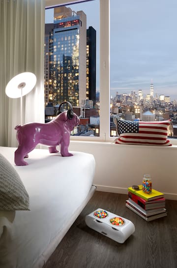 a purple dog statue on a bed