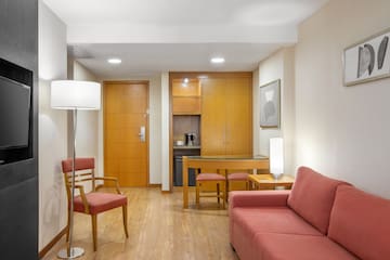 a living room with a table and chairs