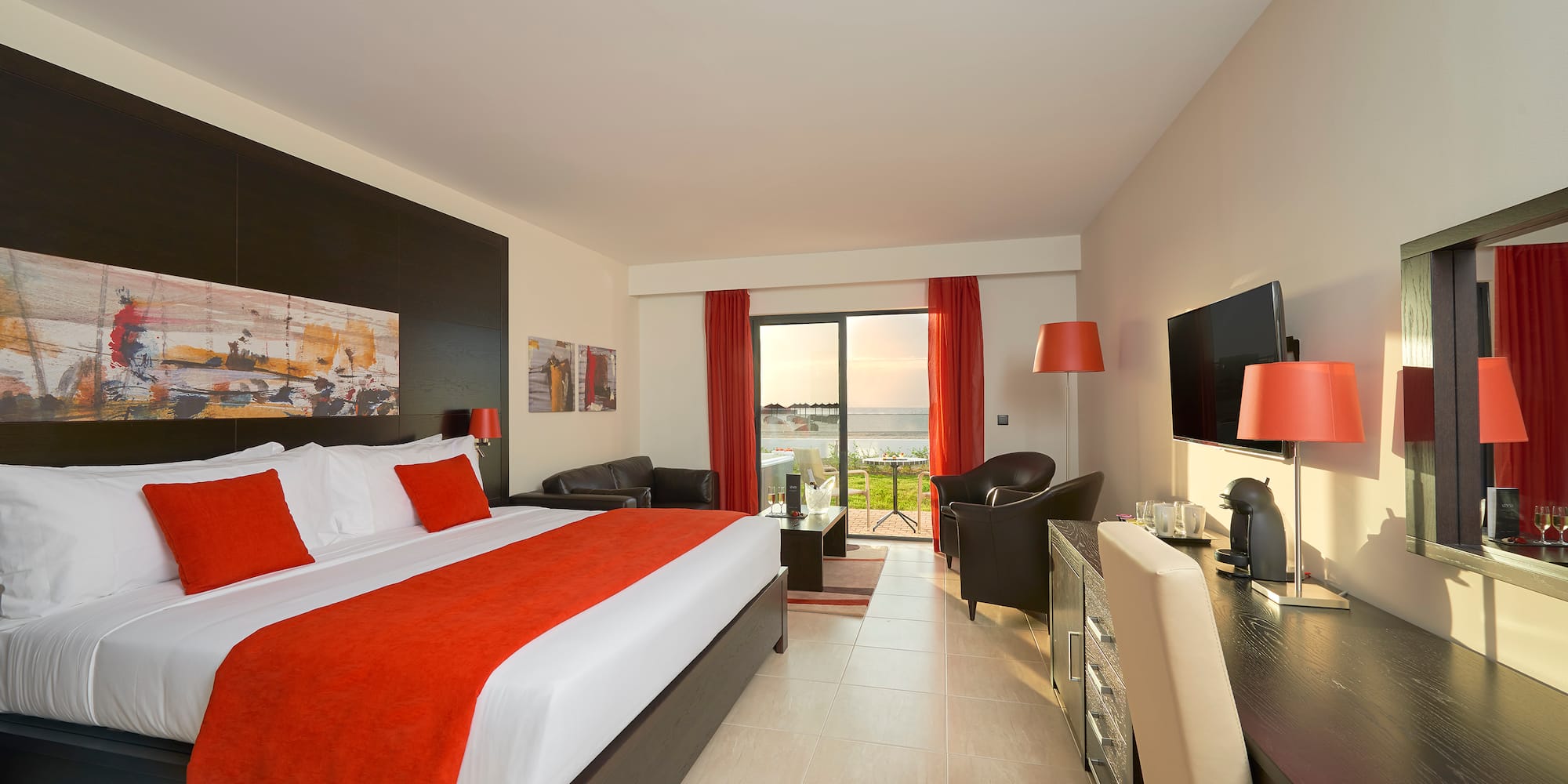 a room with a bed and a television