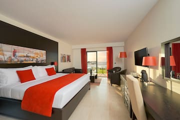 a room with a bed and a television
