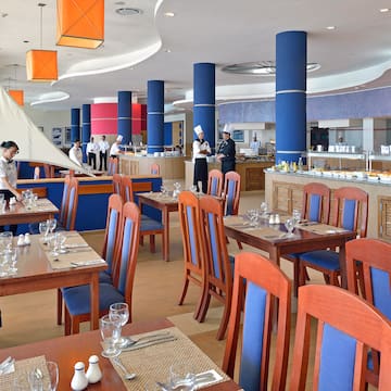 a restaurant with blue chairs and tables