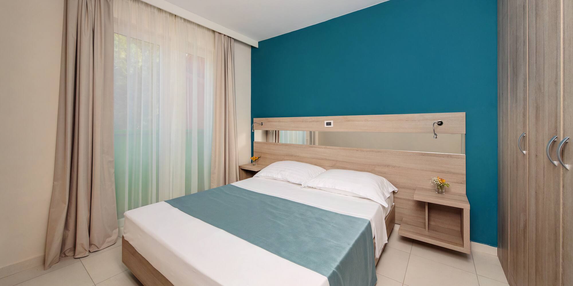 a bed with a mirror in a room