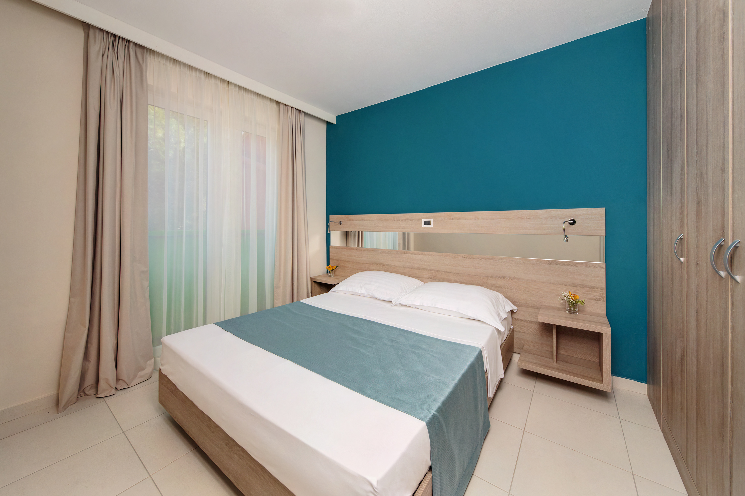 a bed with a mirror in a room