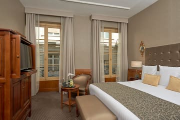 a room with a bed and a television