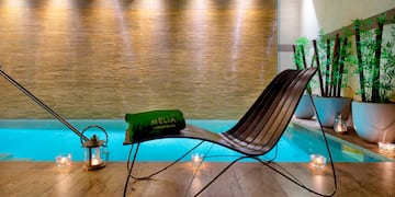 a chair next to a pool