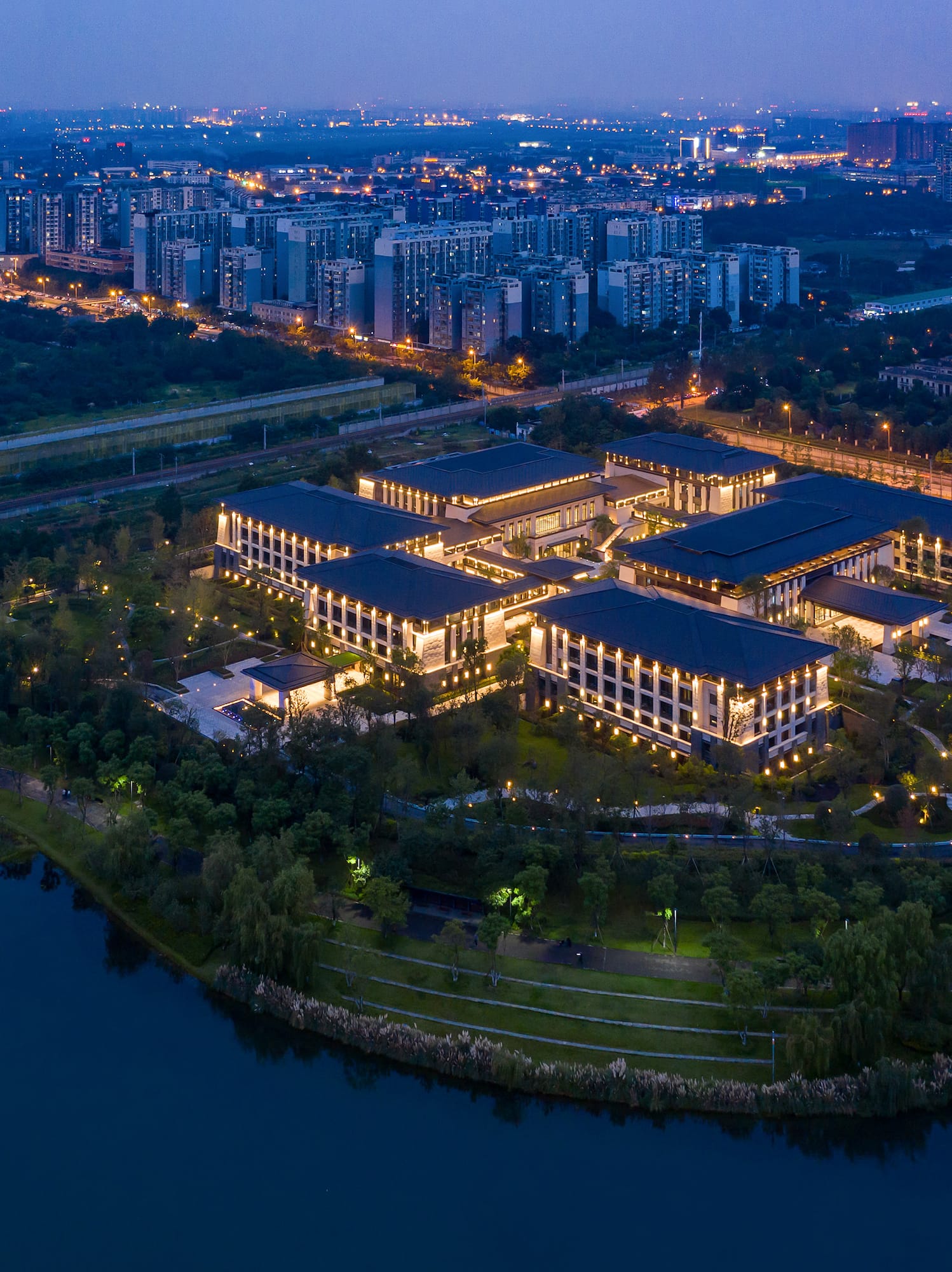 a building with lights on it and a body of water