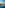 Cadiz Cathedral and waterfront city skyline, rocky breakwater, blue sea.