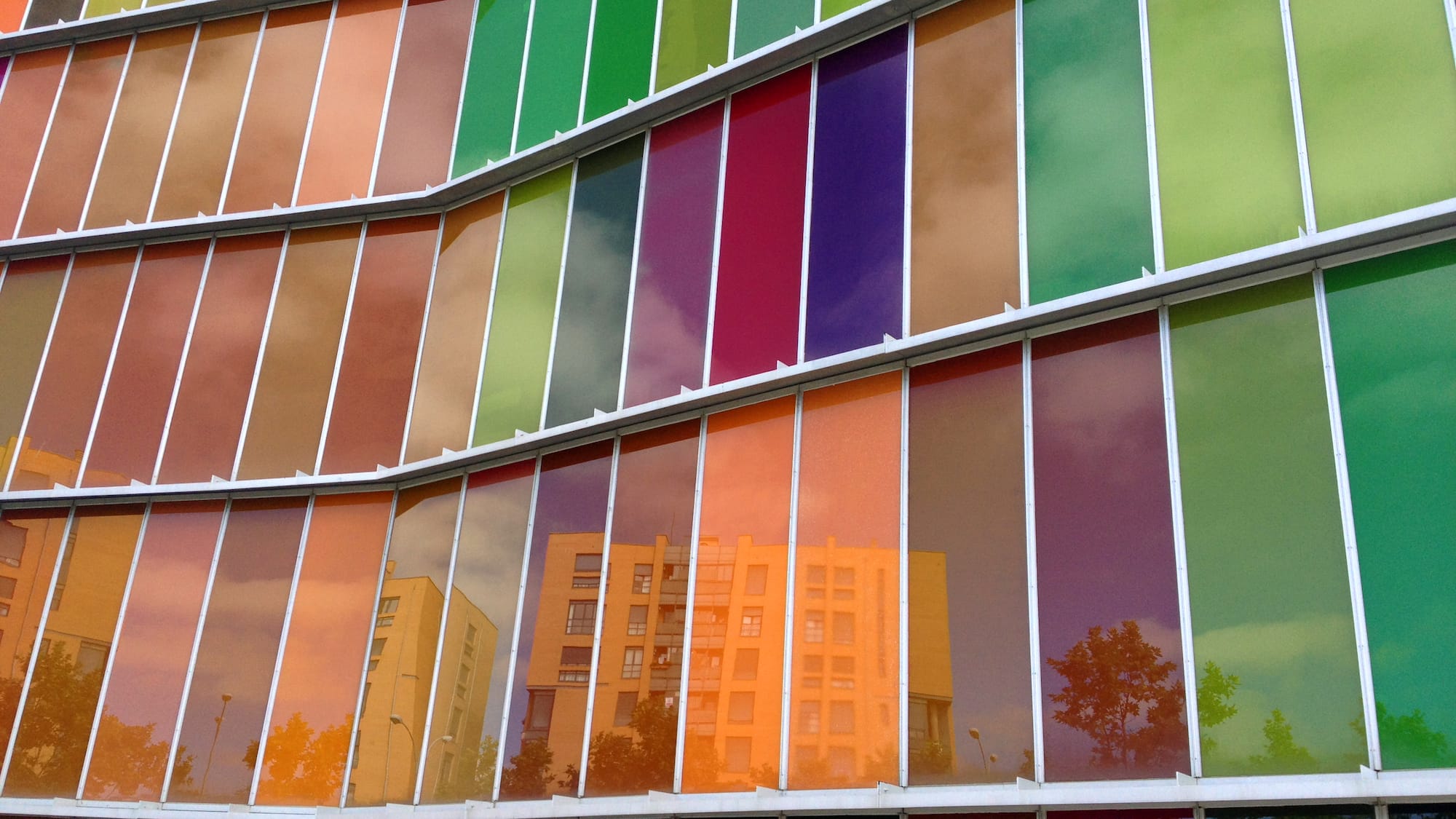 a multicolored glass wall of a building