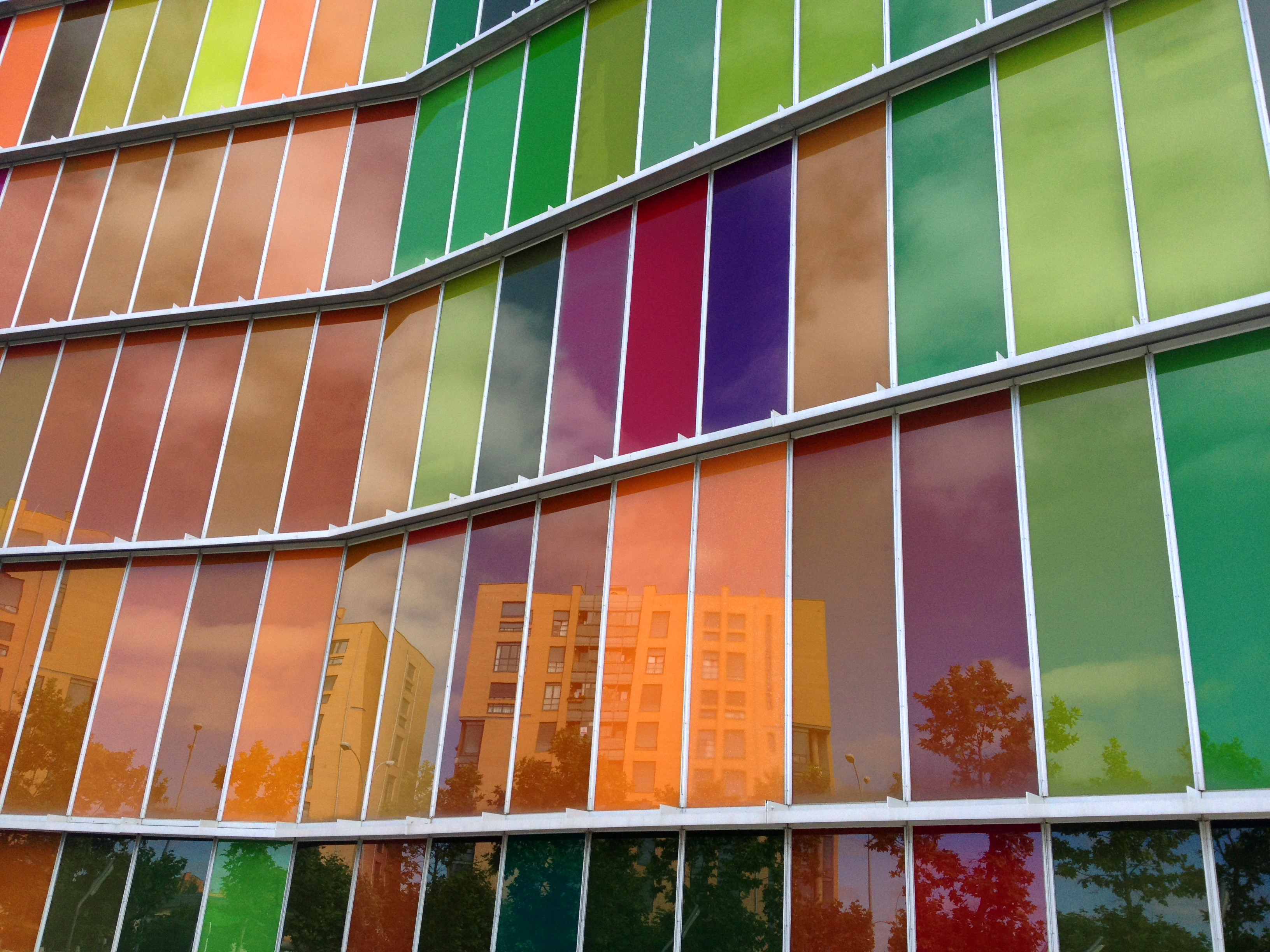 a multicolored glass wall of a building