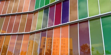 a multicolored glass wall of a building