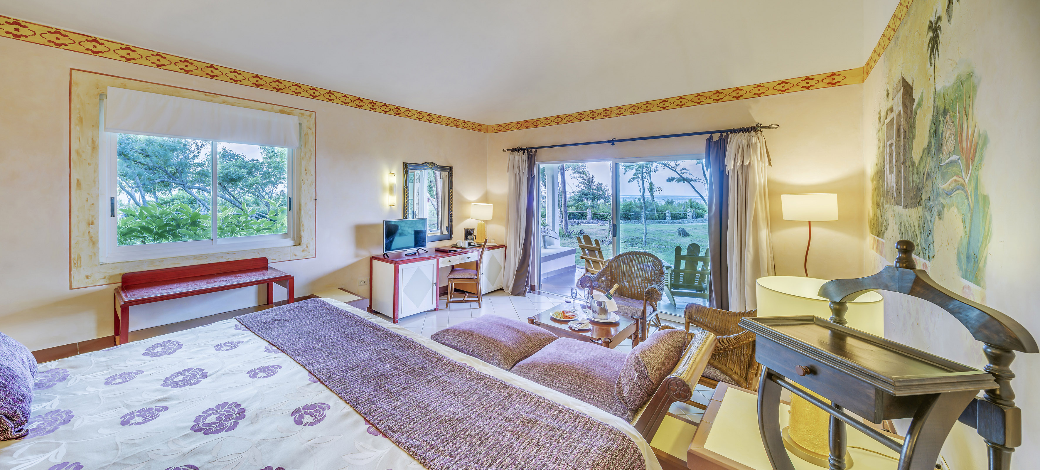 a room with a bed and a desk and chair