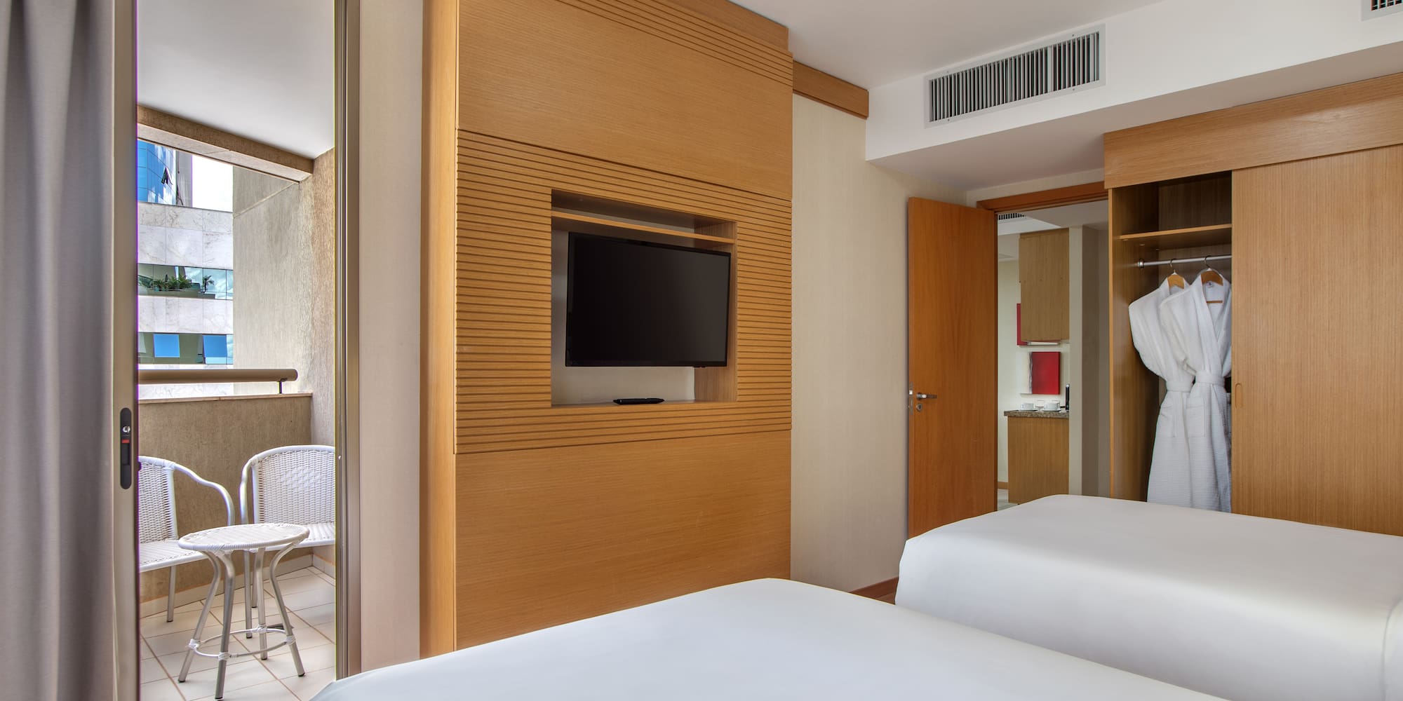 a room with two beds and a tv