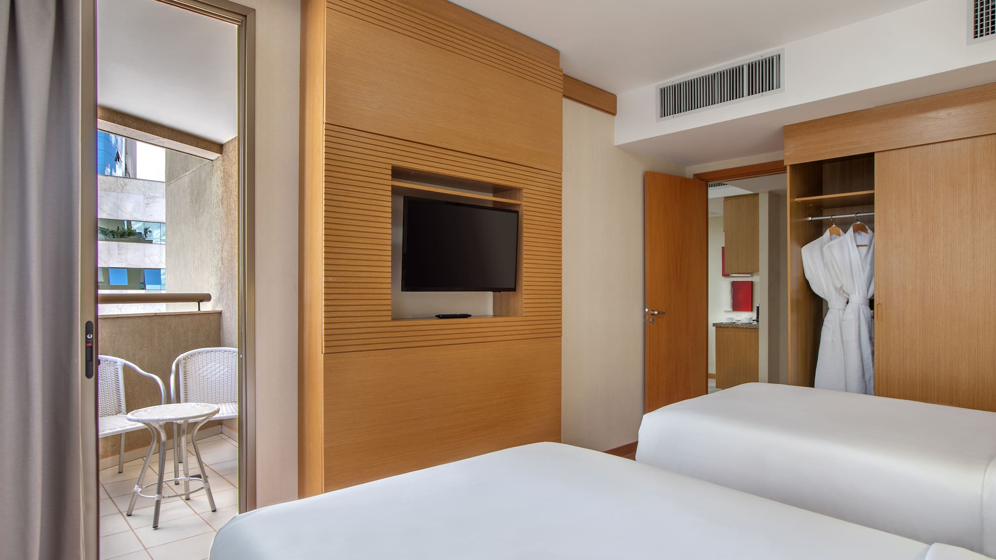 a room with two beds and a tv