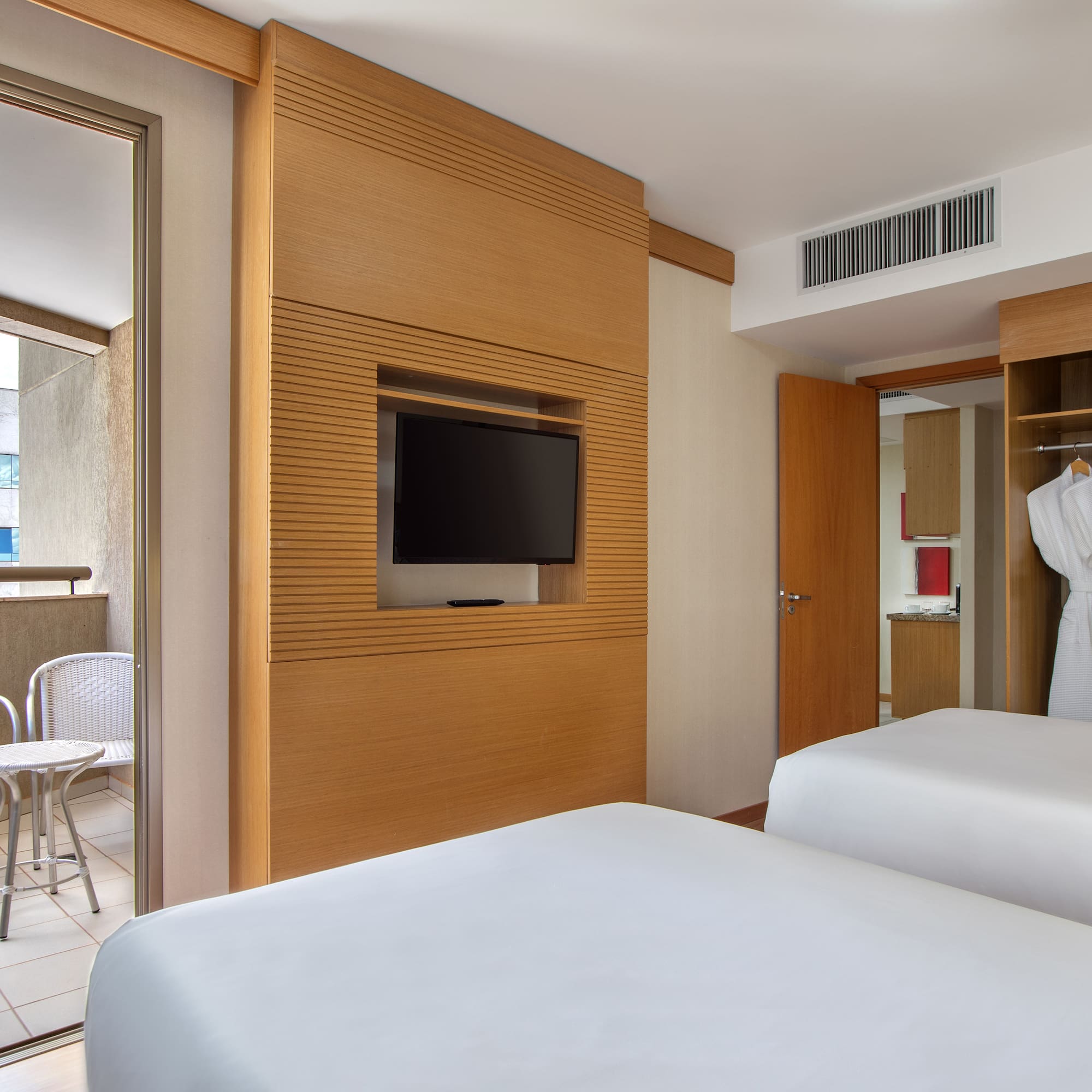 a room with two beds and a tv