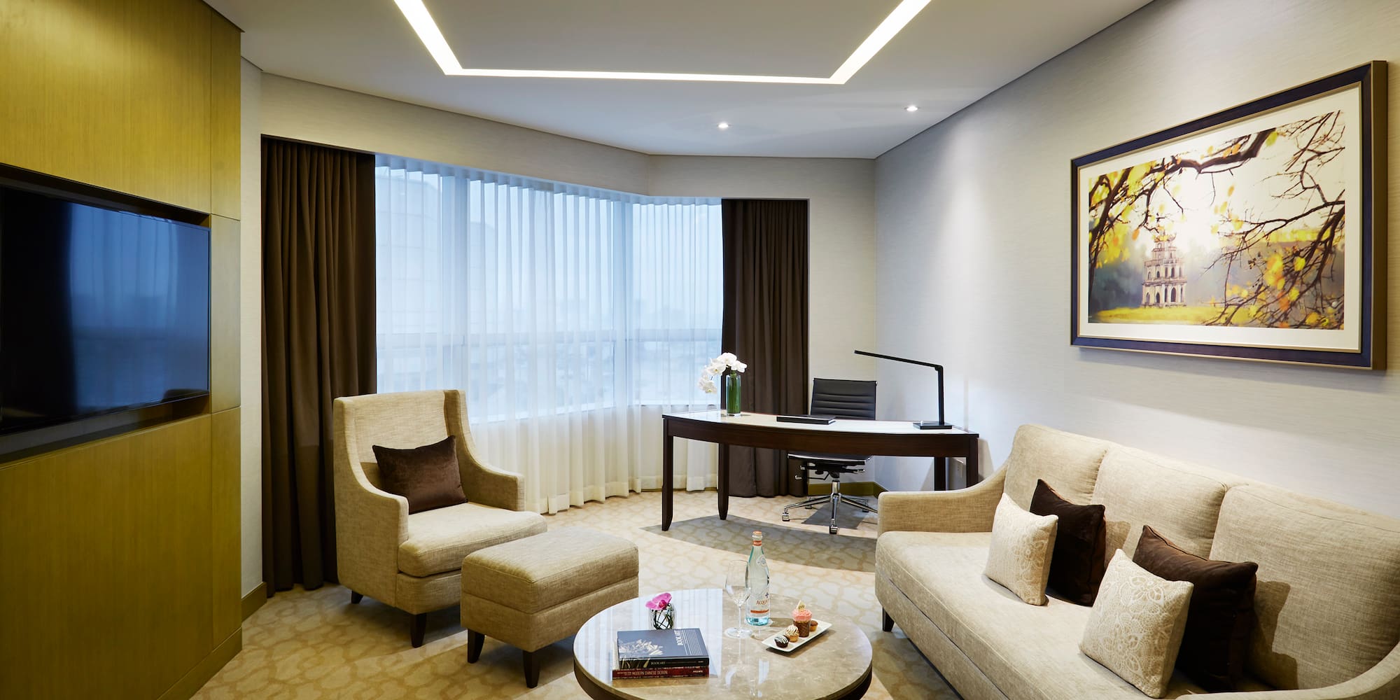 a room with a couch and chairs