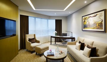 a room with a couch and chairs