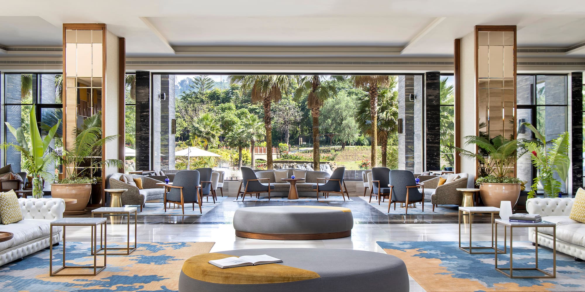 a large room with a large round couch and chairs