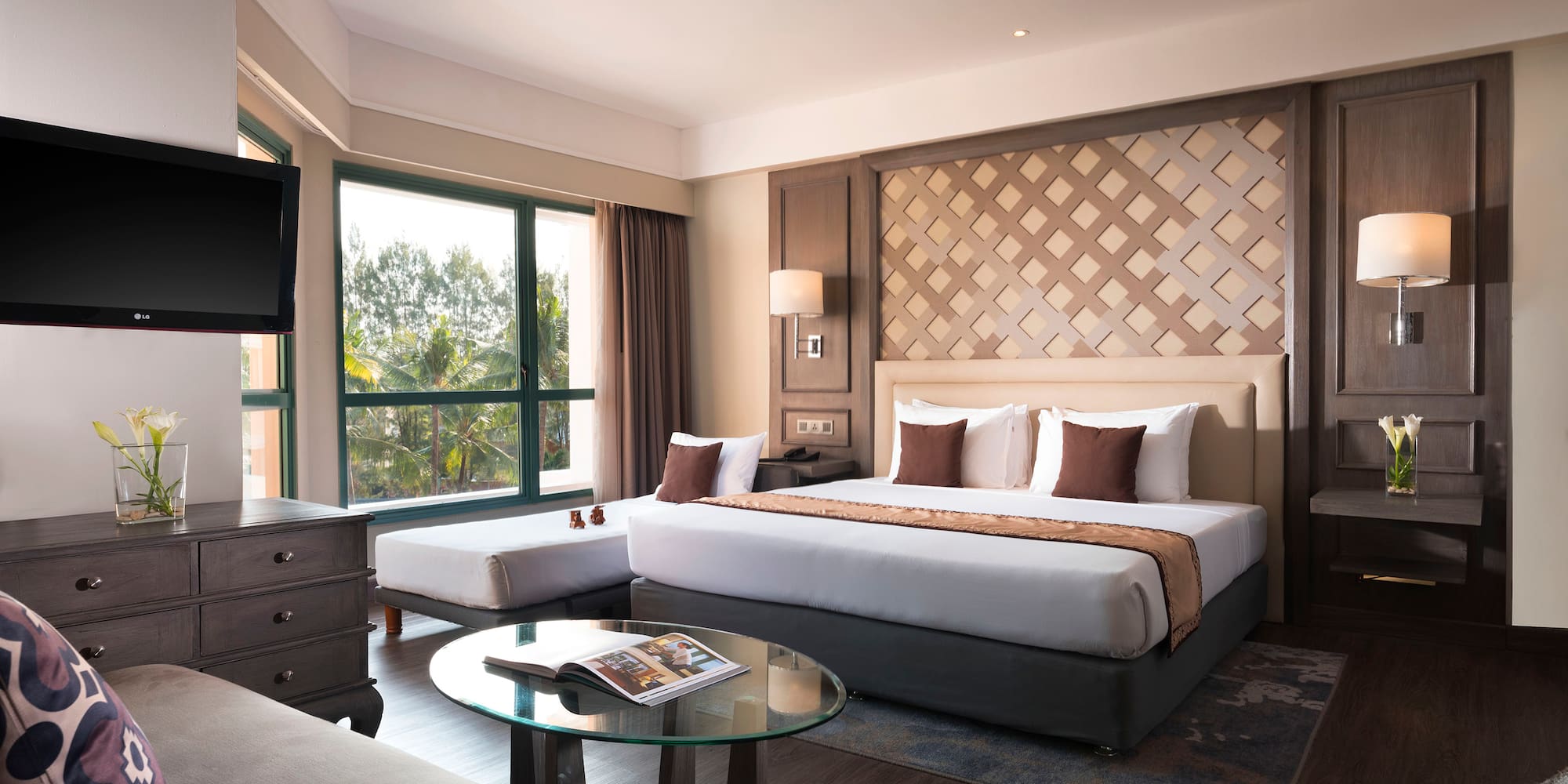 a room with a bed and a television