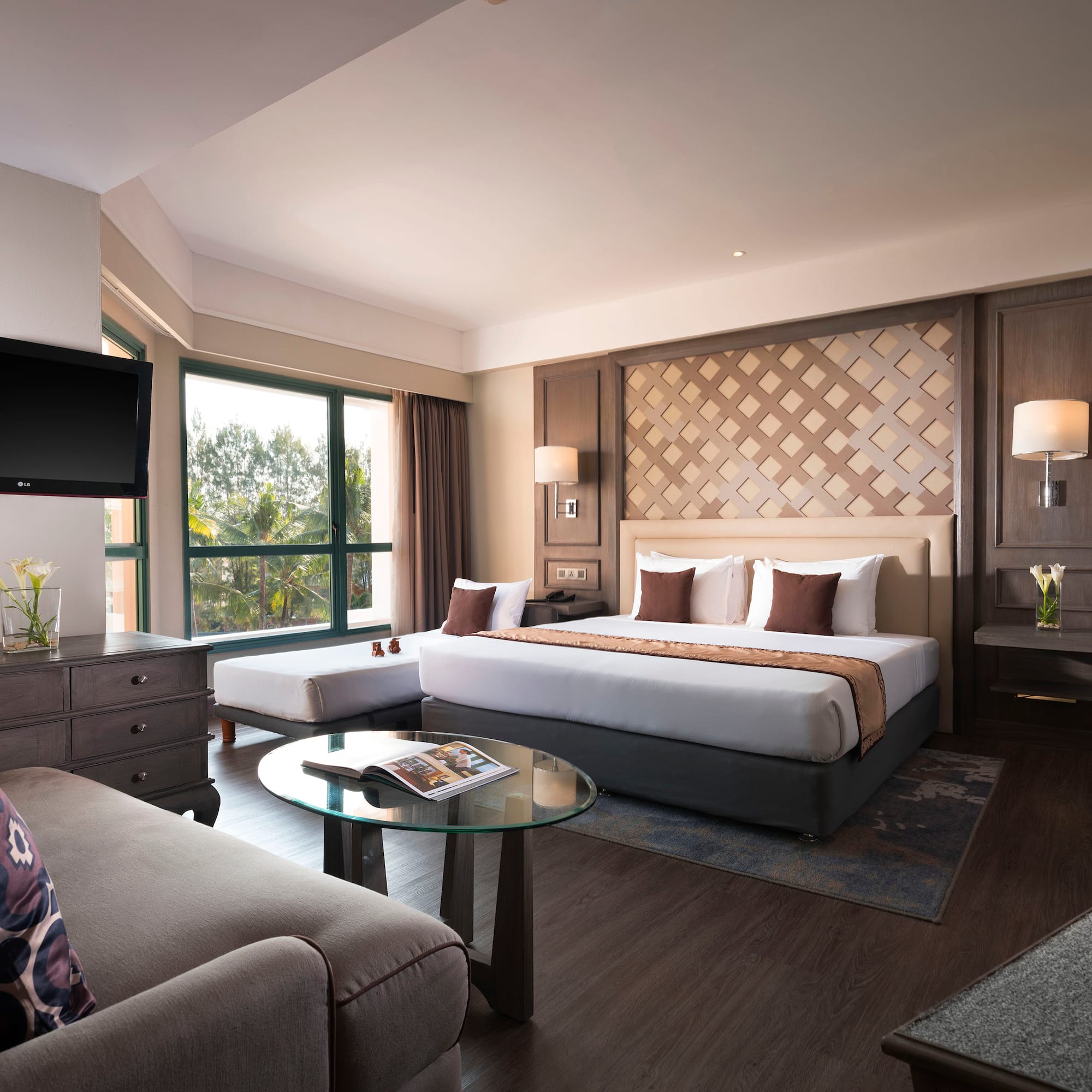 a room with a bed and a television