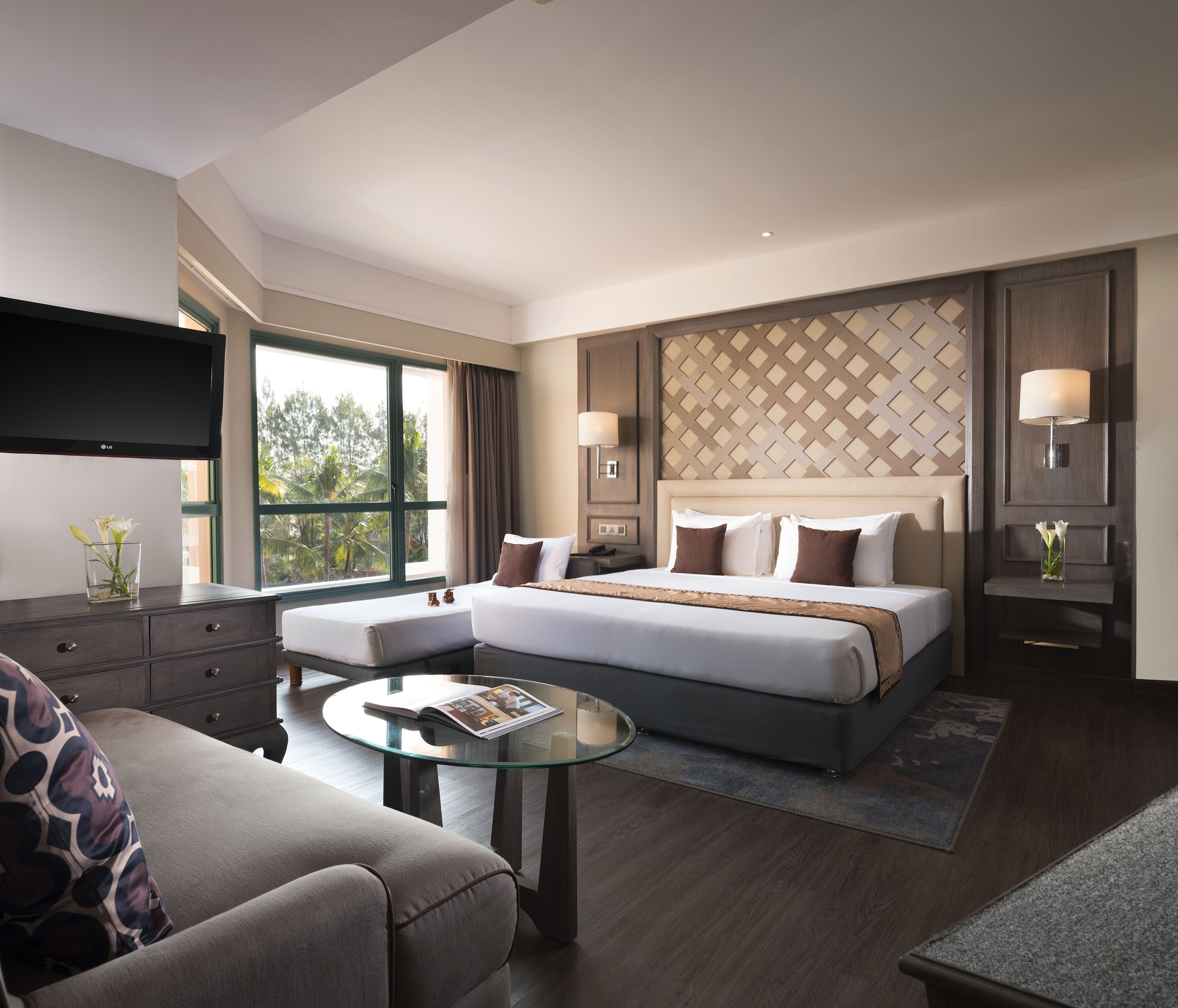 a room with a bed and a television