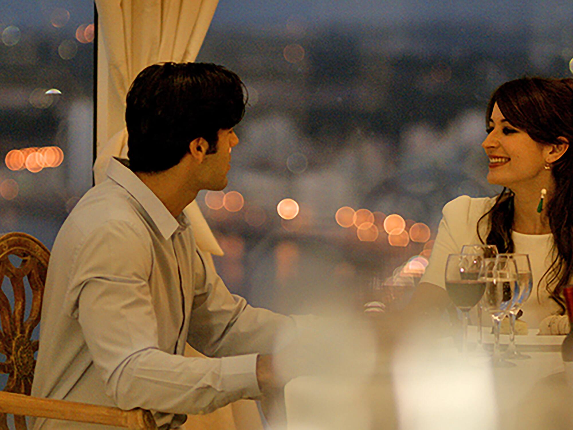 a man and woman sitting at a table