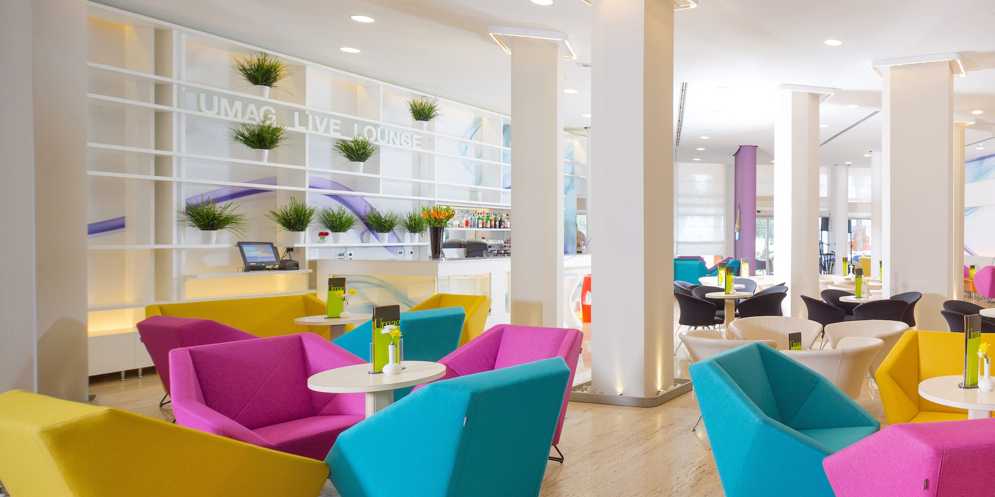 a room with colorful chairs and tables