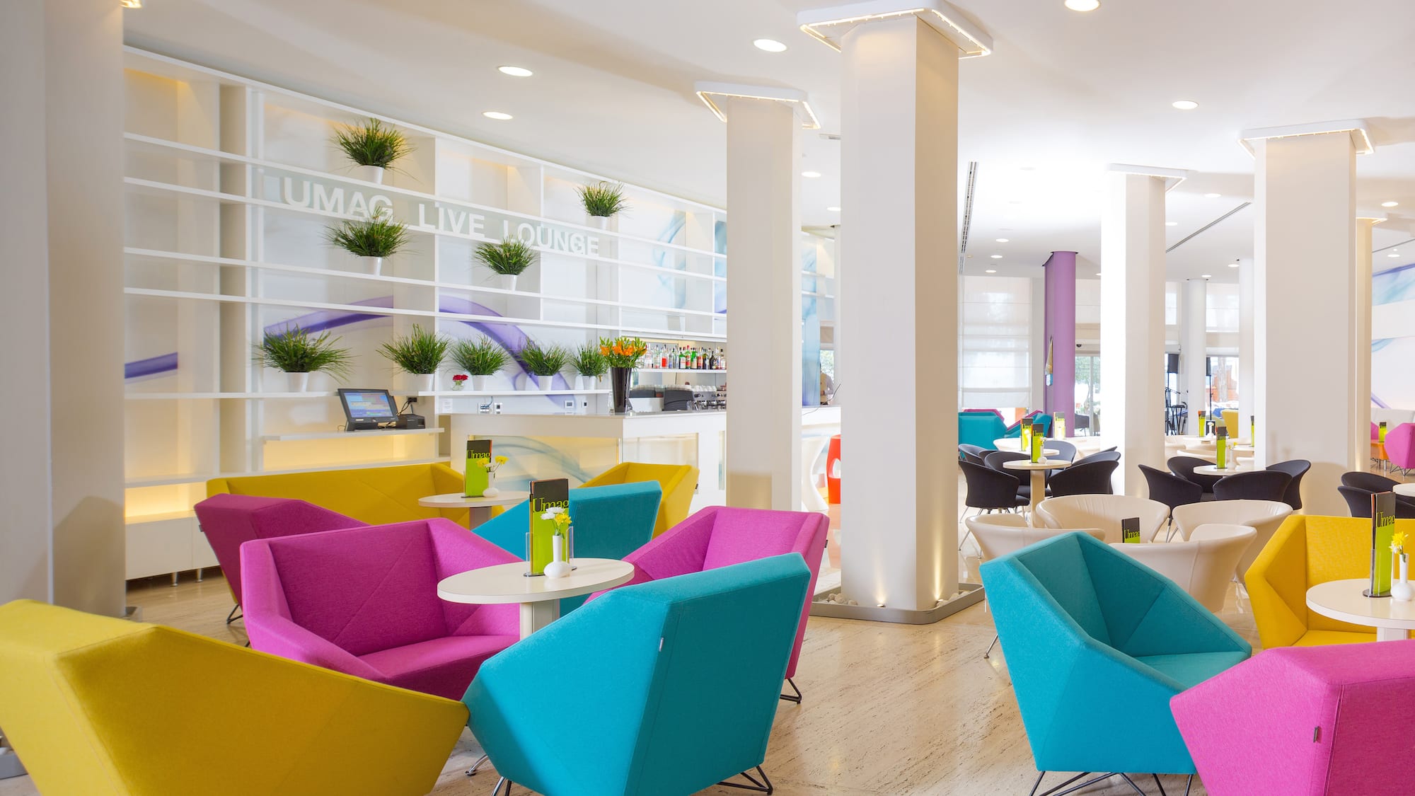 a room with colorful chairs and tables