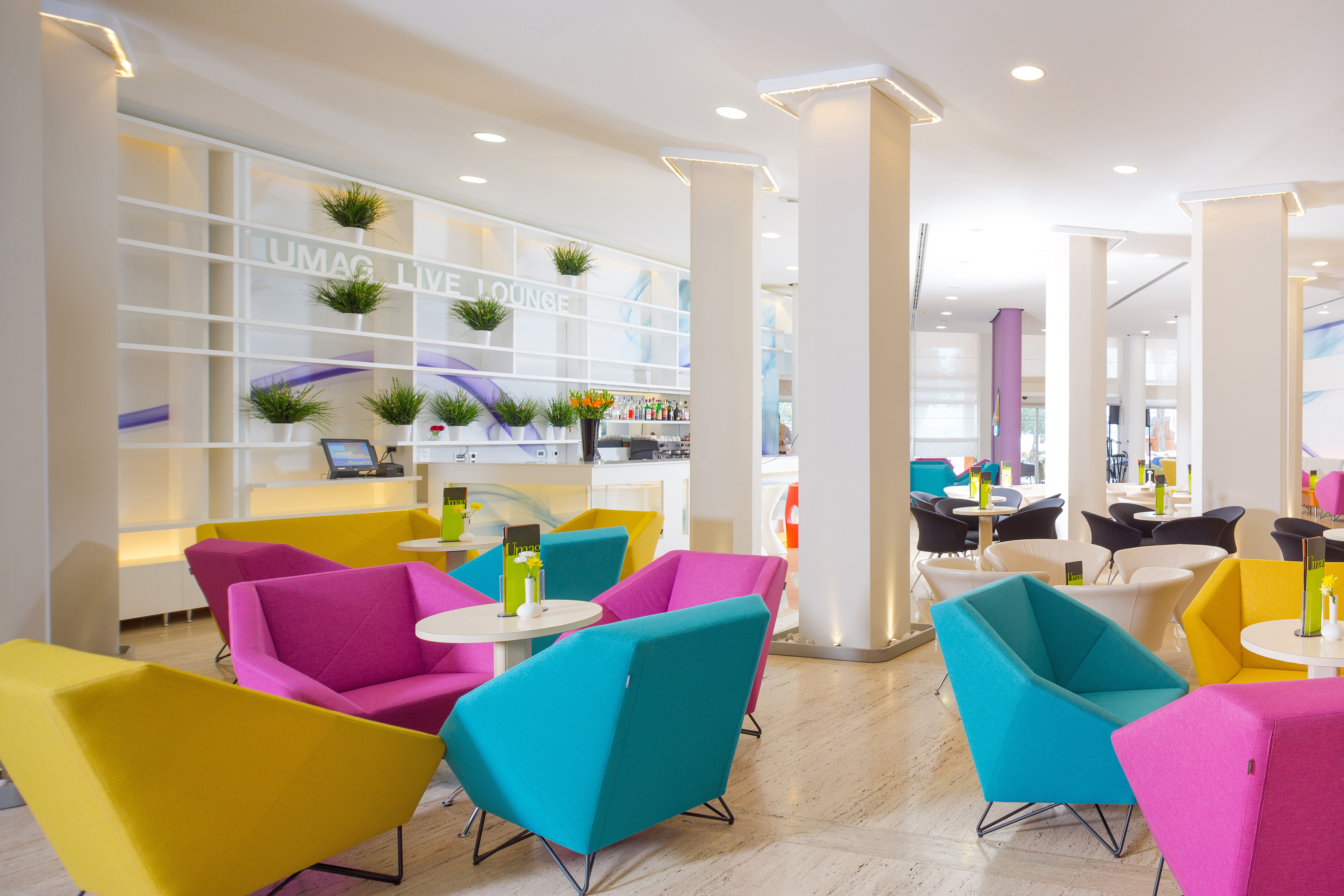 a room with colorful chairs and tables