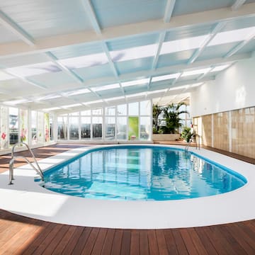 a indoor pool with a wood floor and a wood floor