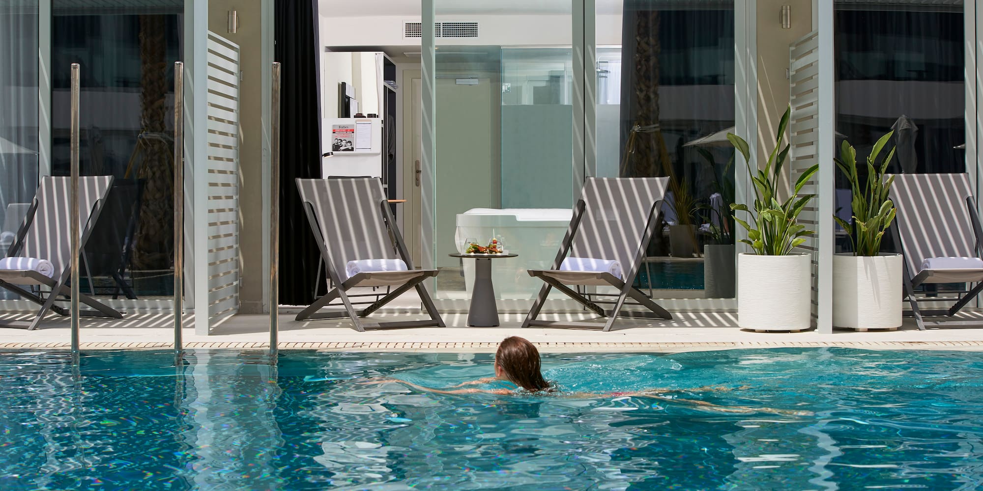 a woman swimming in a pool