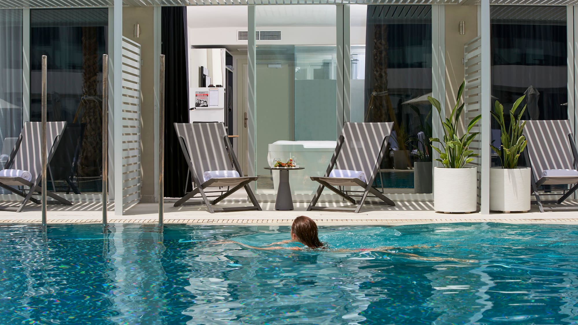 a woman swimming in a pool